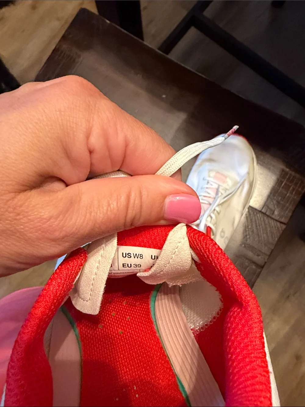 On Running White Athletic Shoes with Pink and Red Accents
